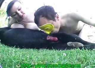 Gentleman and busty mature babe share black dog's dick outdoors