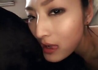 Seductive Japanese babe passionately making out with a black dog