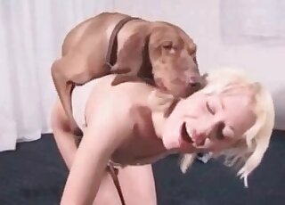 Blond-haired chick with a firm ass is getting fucked by a nasty dog