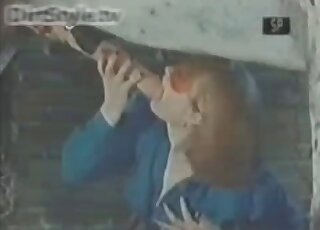 Redheaded lady dressed in blue blows a hung horse with passion