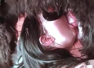 Attractive babe in a black mask is ready to suck on furry dicks too